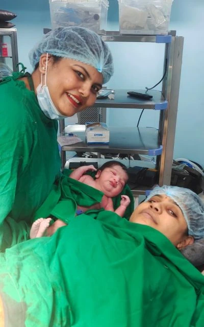 Dr. Pranali Meshram caring for a newborn baby with professional maternity support in a hospital